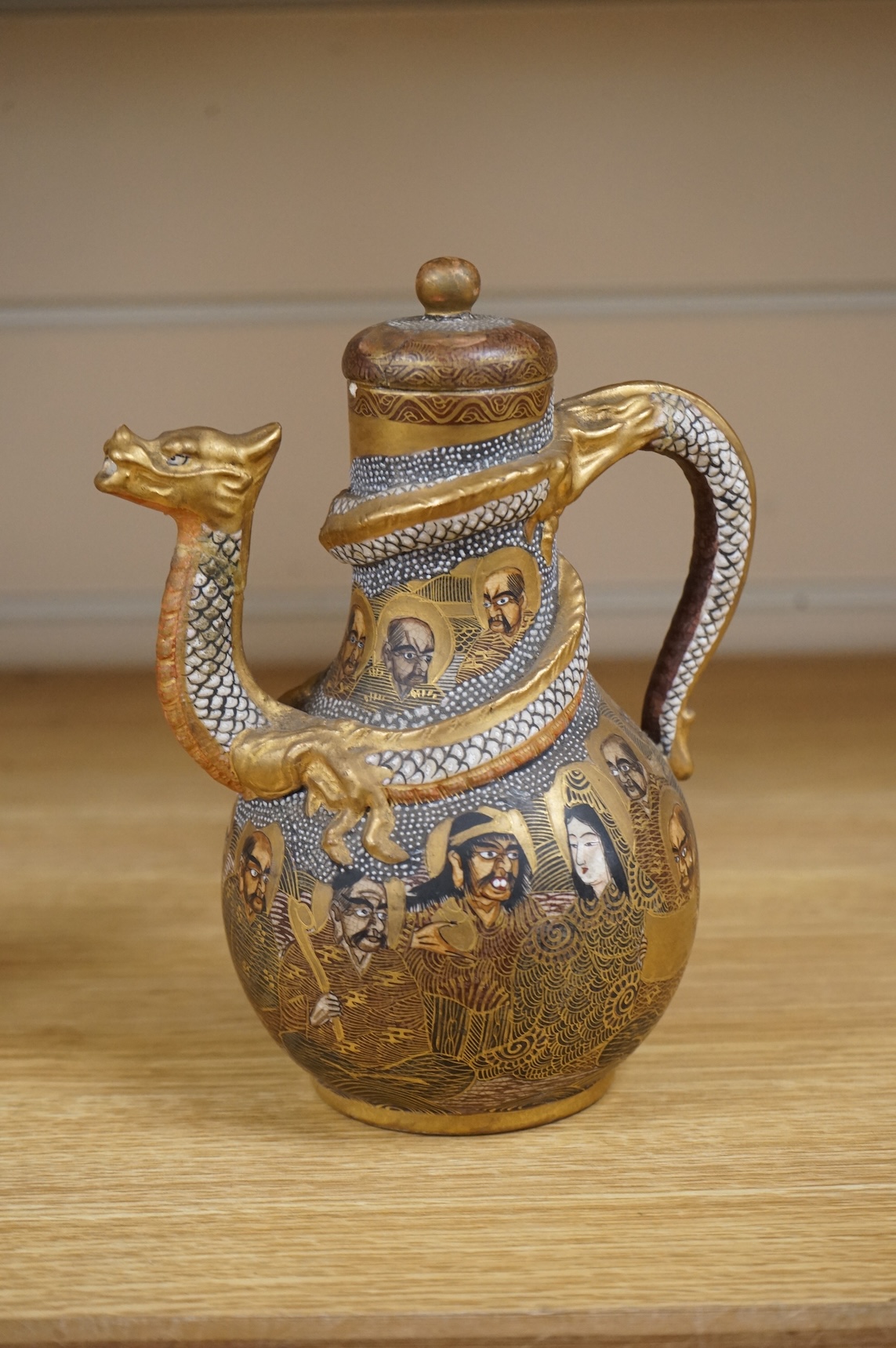 A Japanese Satsuma teapot and cover, signed, 17cm